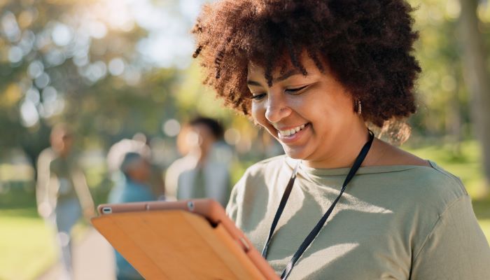 Woman smiling and holding a clipboard